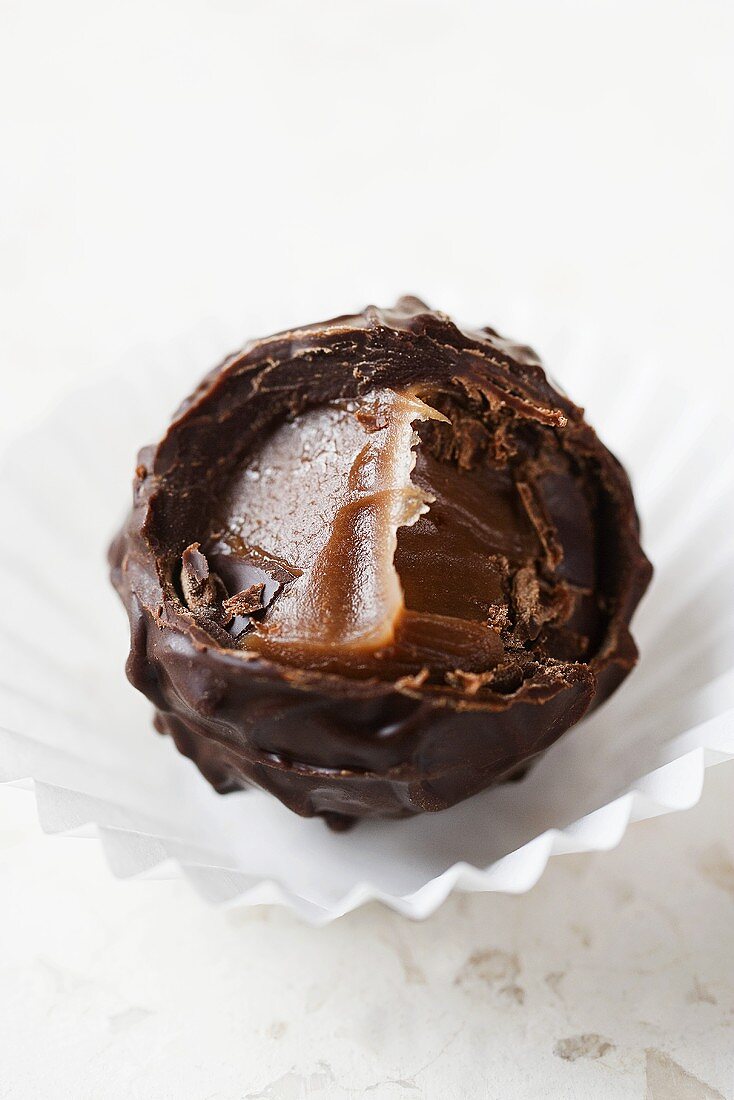 A truffle praline with a bite taken out