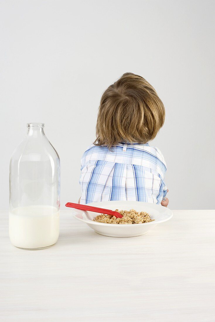 A boy who doesn't like his breakfast