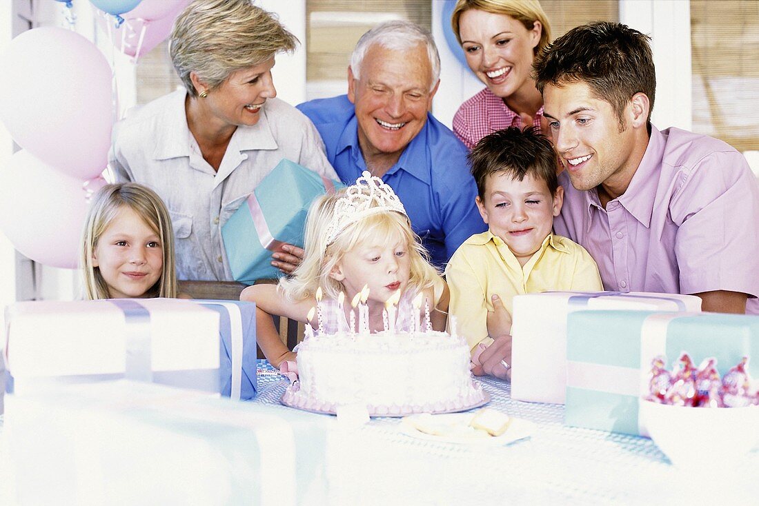 A girl blowing out candles