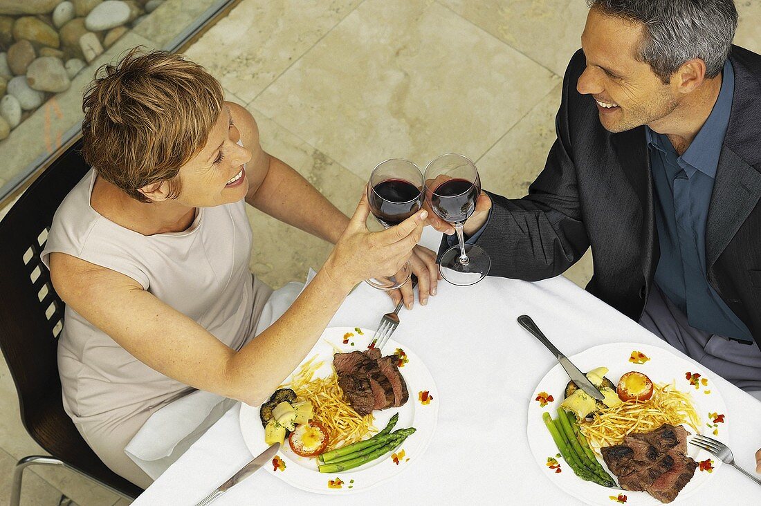 A man and woman having a romantic meal