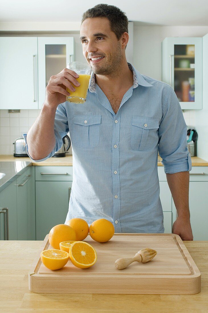 A man drinking freshly squeezed orange juice