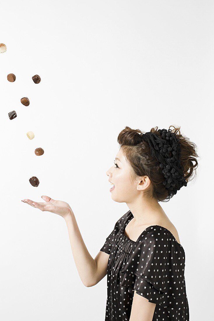A woman throwing chocolates in the air