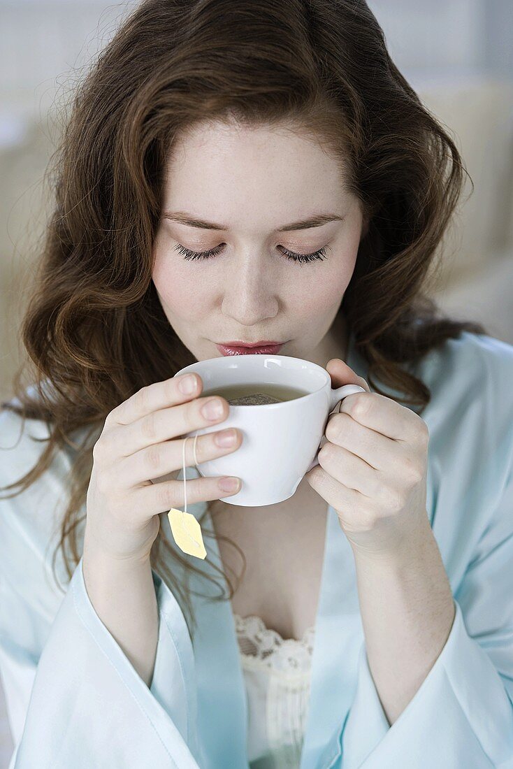 Woman having herbal tea