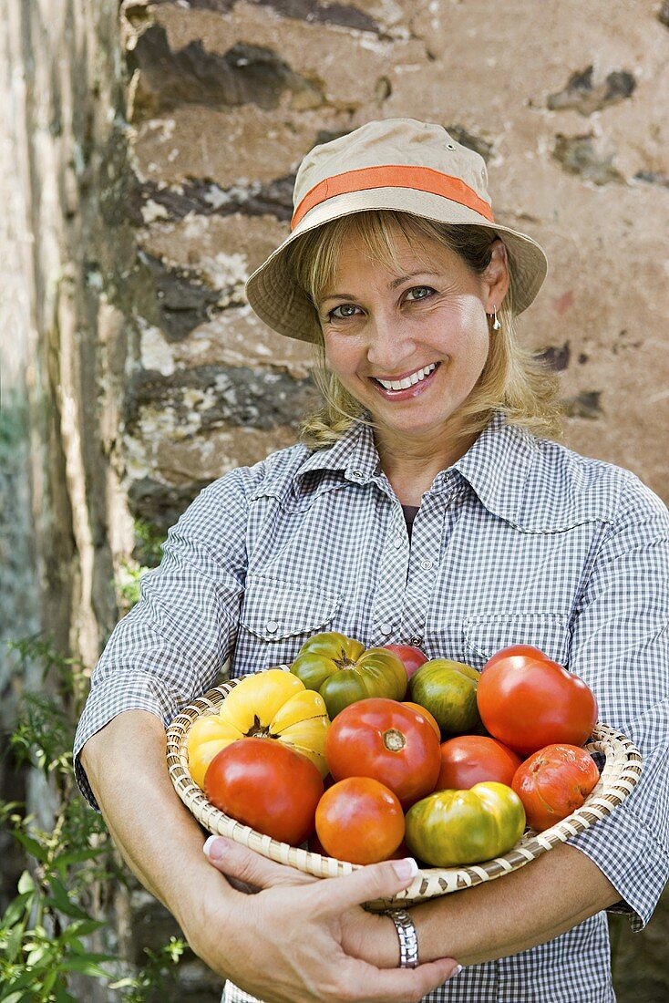 Woman with bowl of tomatoes