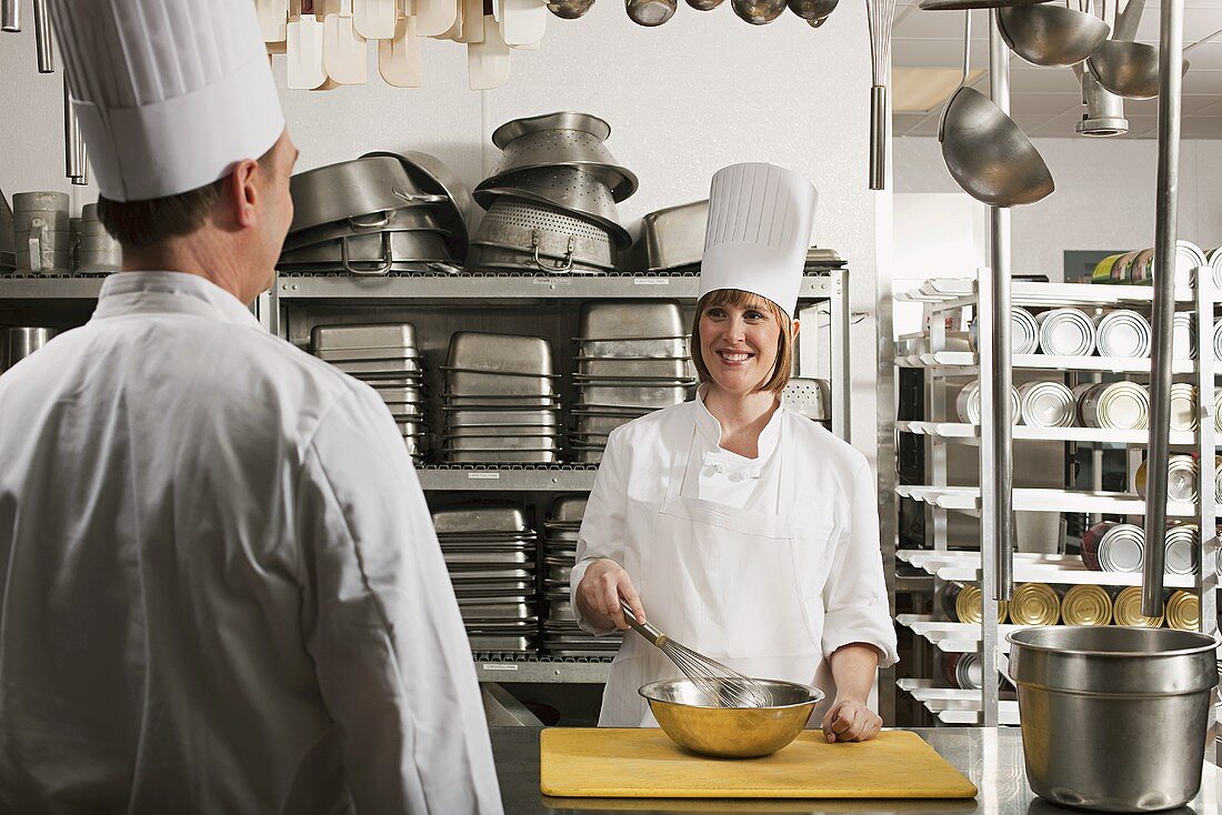 Chefs preparing food in a commercial kitchen