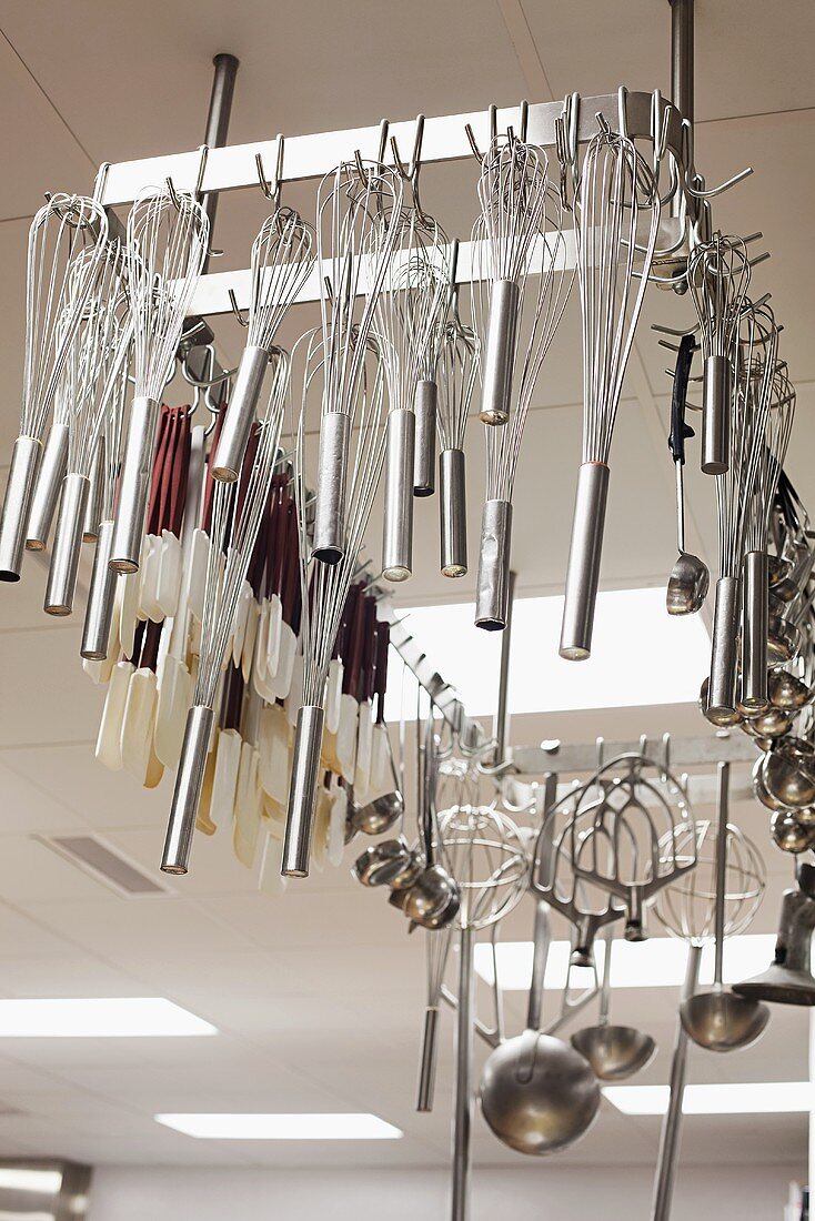Kitchen utensils hanging in a commercial kitchen