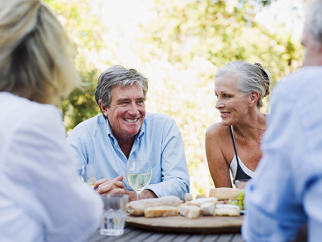 Friends at meal outdoors