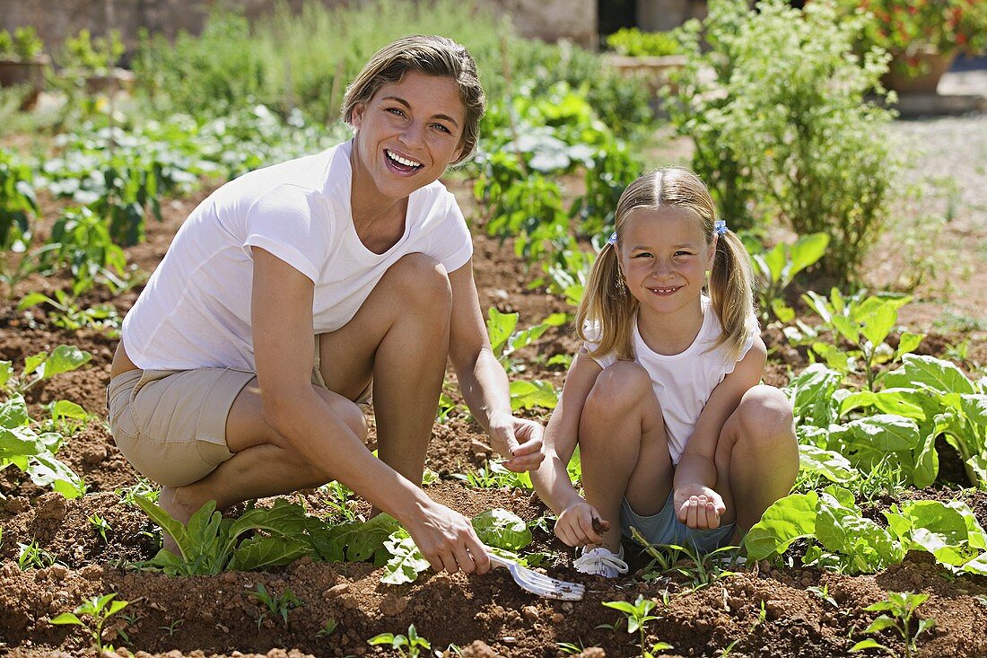 A mother and daughter gardening