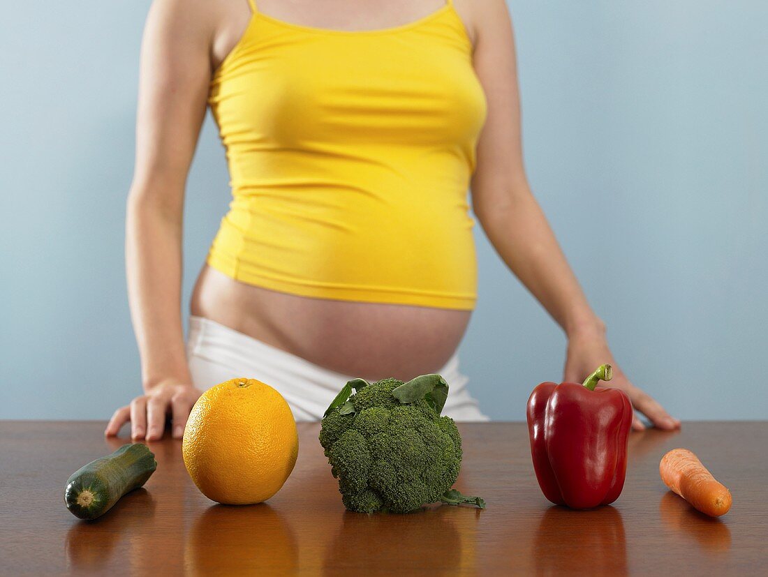 A pregnant woman with fruit and vegetables