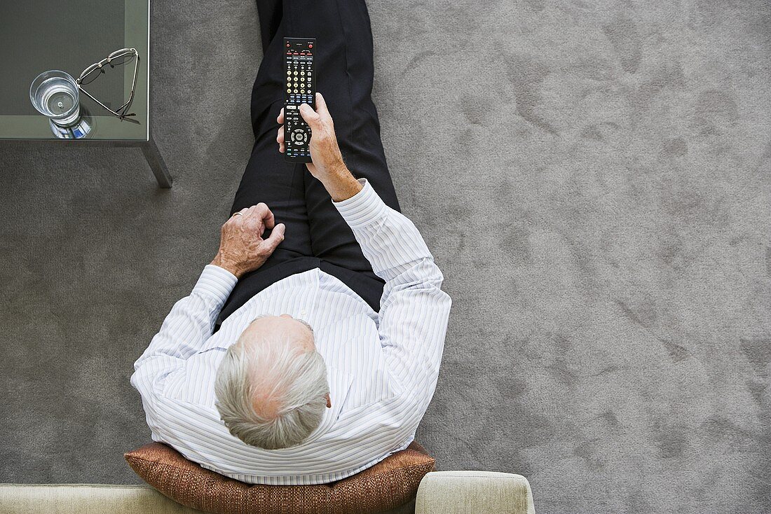 An older man watching television