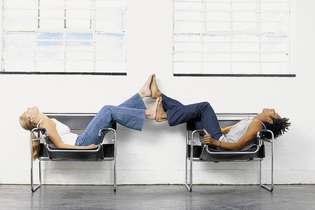 Couple playing on chairs