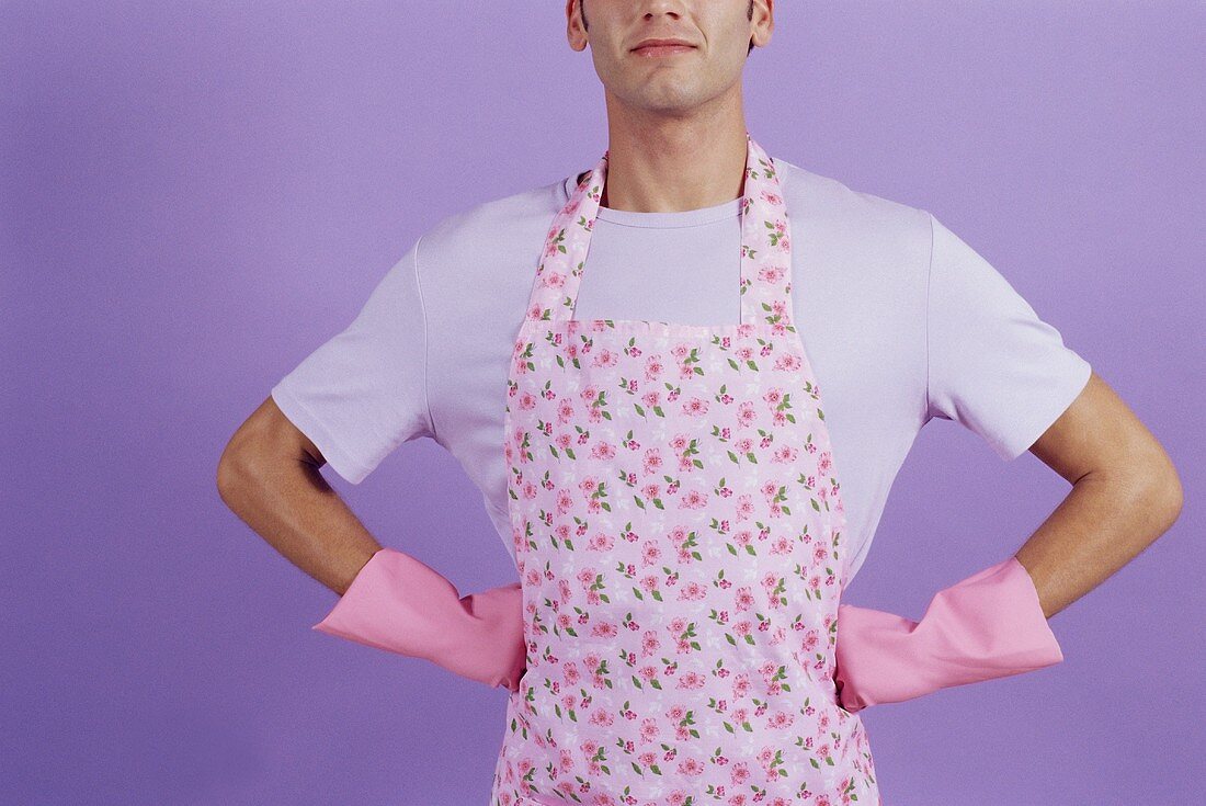 A man in an apron and rubber gloves