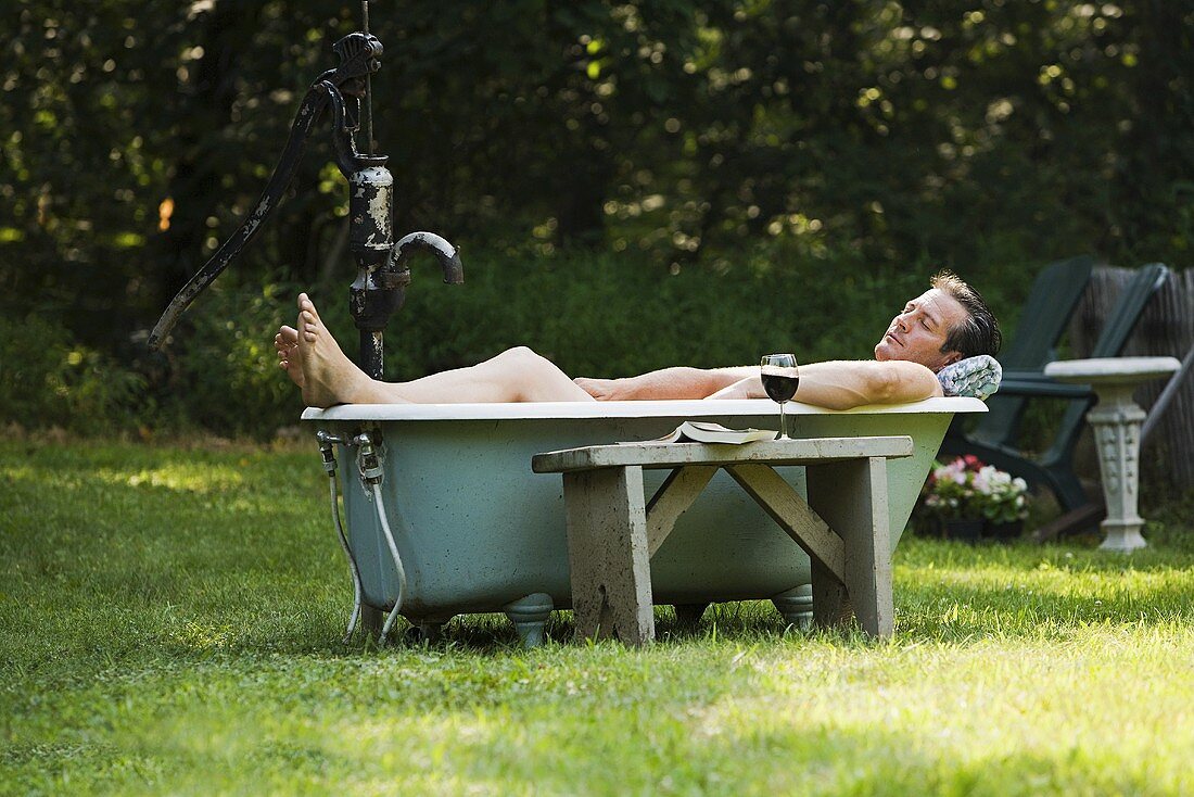 Man in outdoor bathtub