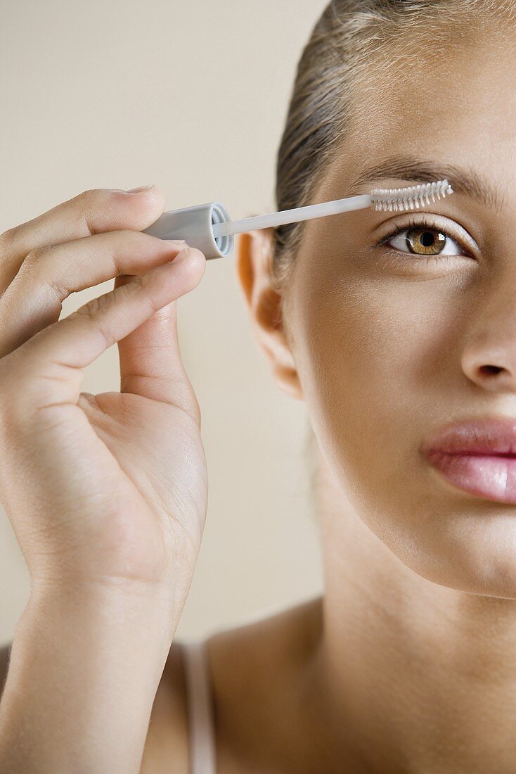 A girl applying mascara