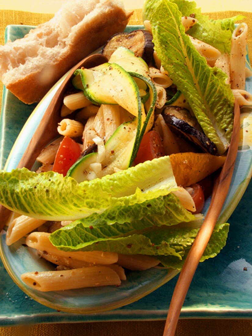 Pasta salad with vegetables and romaine lettuce