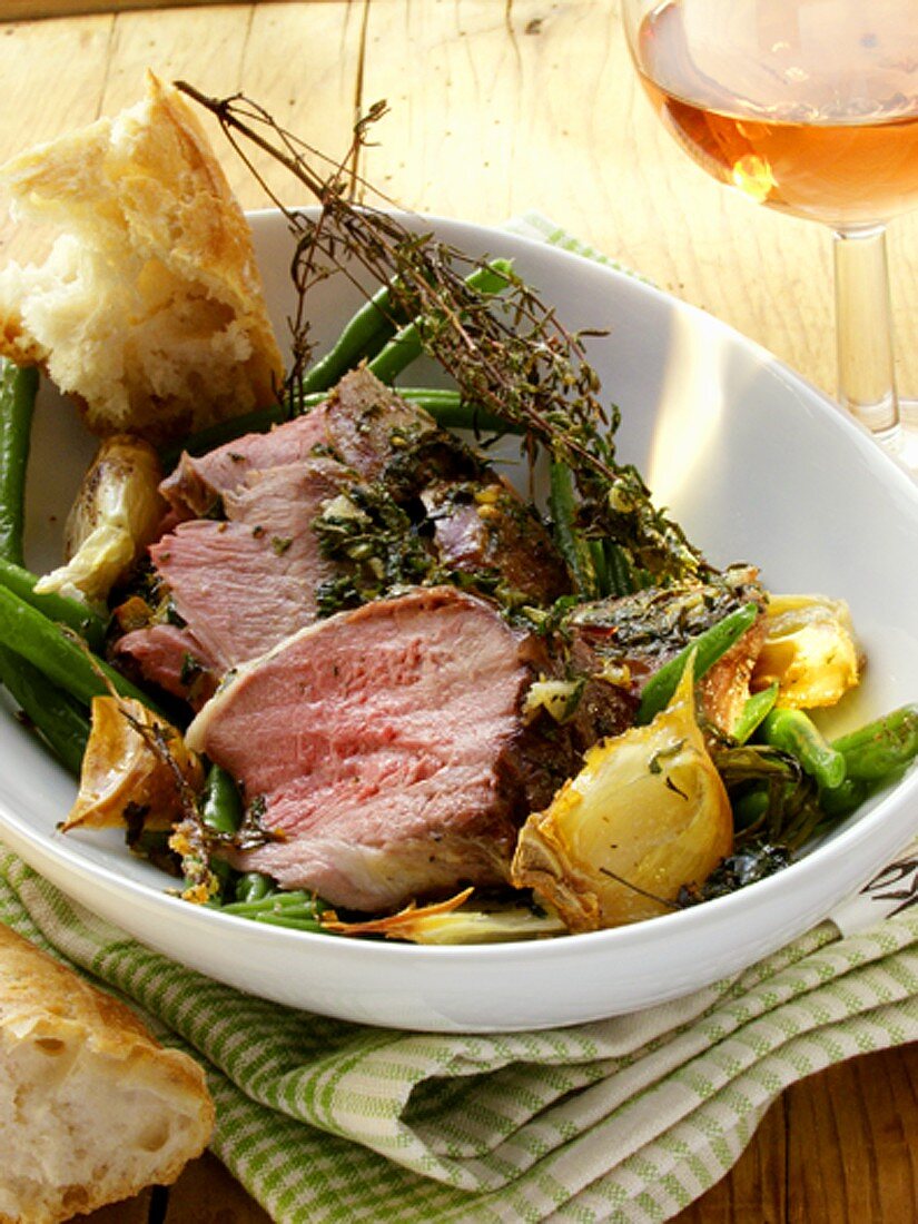 Leg of lamb with herbs, green beans and baguette