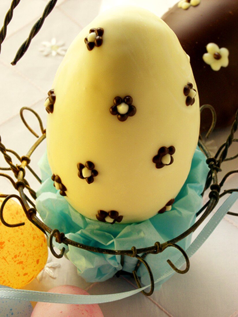 White chocolate egg in Easter basket