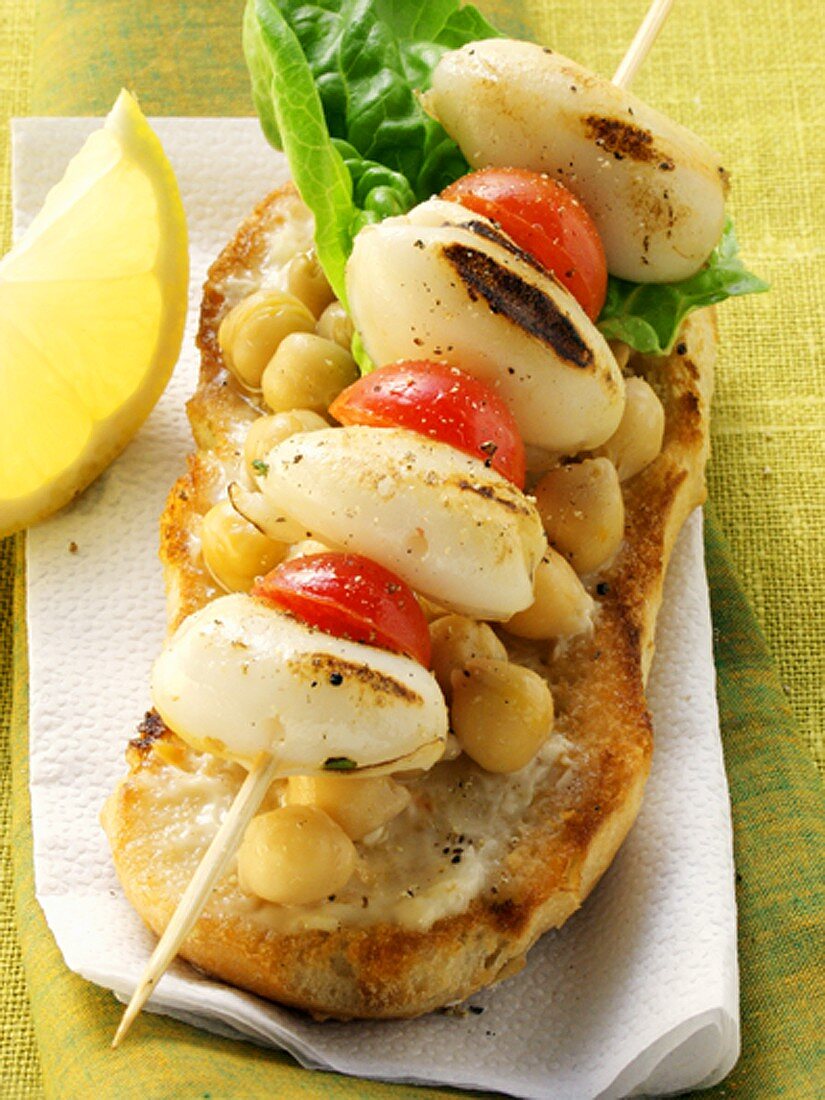 Cuttlefish & cherry tomato kebab on bread with chick peas