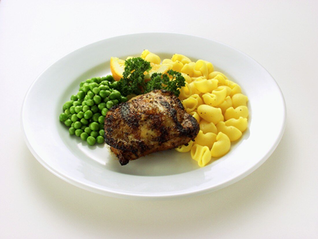 Barbecued chicken breast with noodles and peas