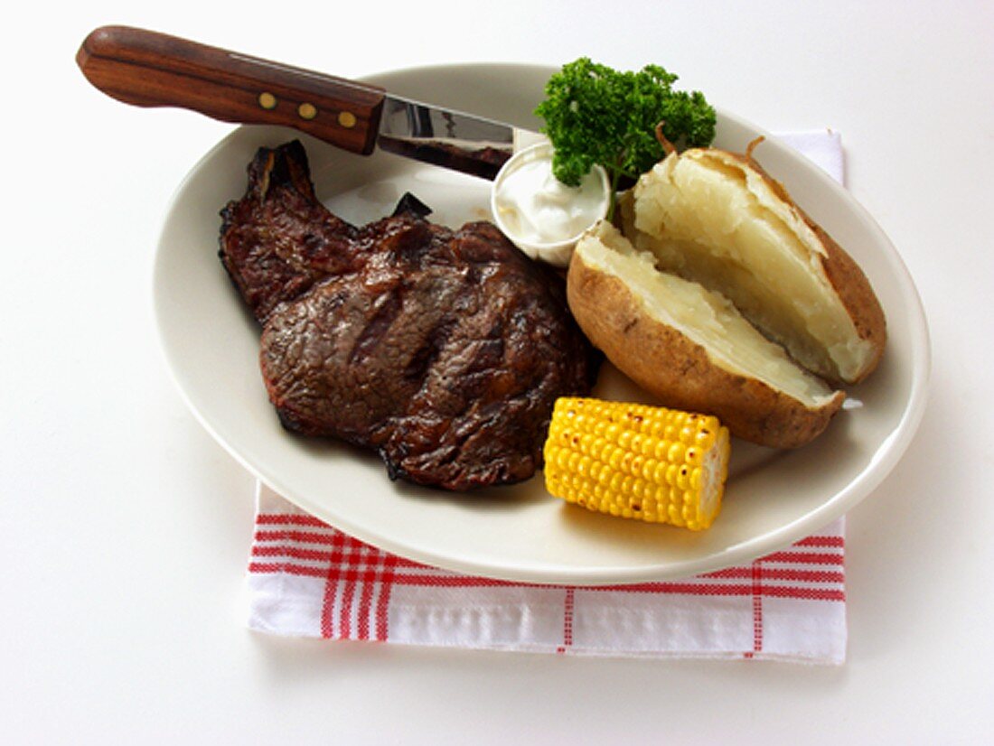 Boneless ribeye steak with baked potato & sour cream
