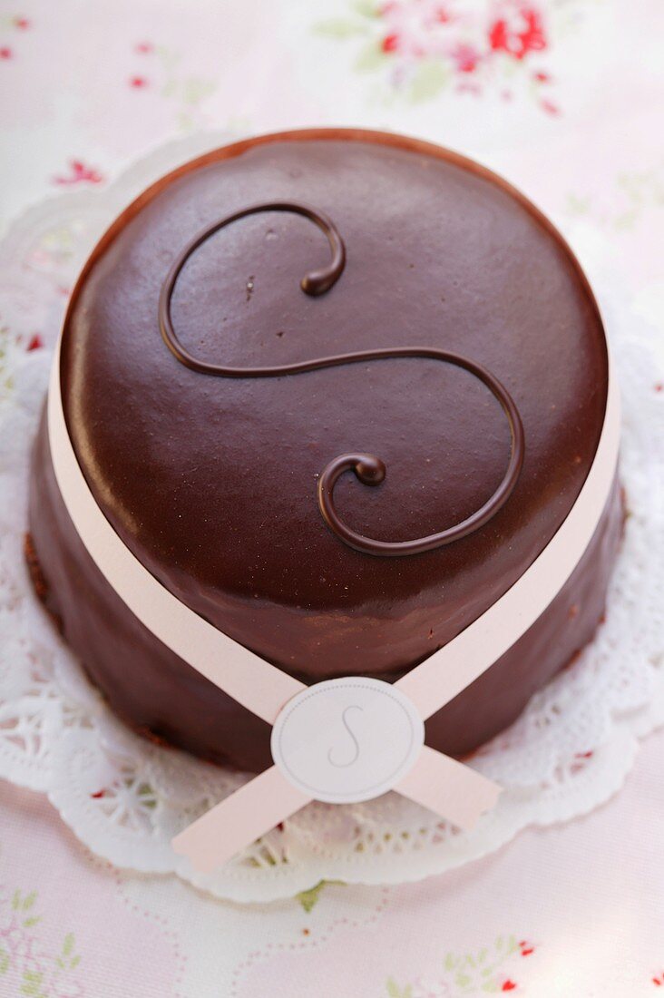 Sacher torte with paper bow on doily