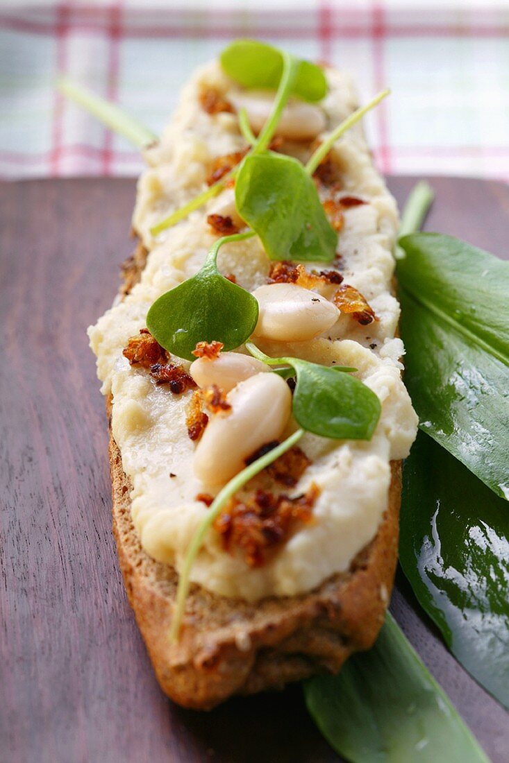 Baguette with bean paste, bacon and watercress