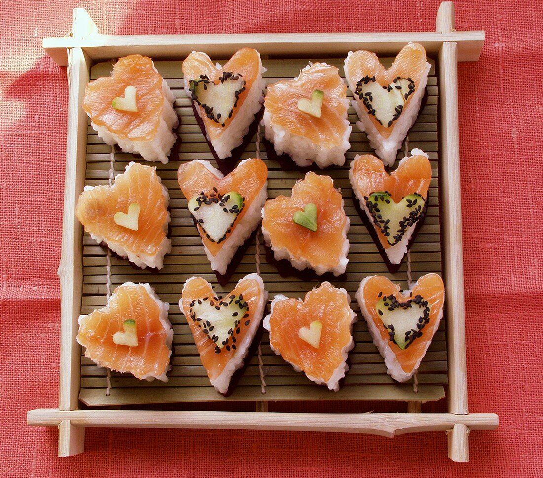 Heart-shaped sushi with salmon, cucumber and sesame