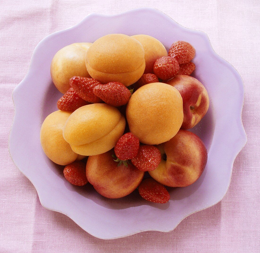 Aprikosen, Nektarinen und Erdbeeren auf Teller von oben