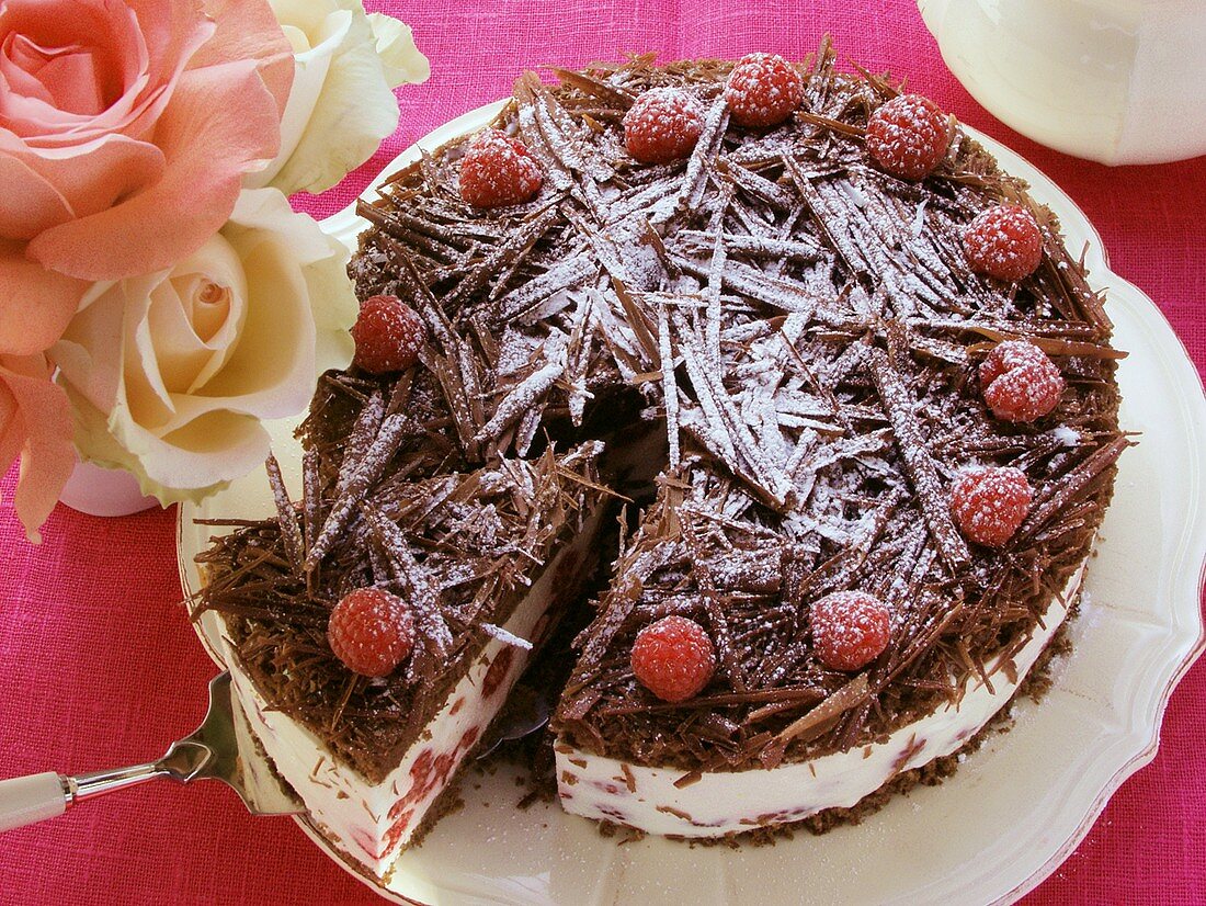 Schokoladen-Himbeer-Torte mit Puderzucker, angeschnitten