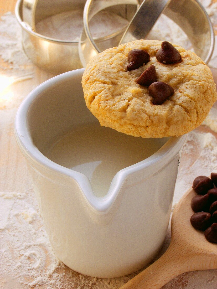 Chocolate chip cookie, baking utensils and ingredients