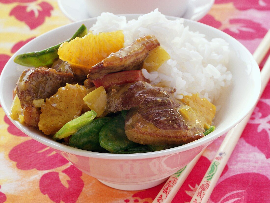 Roast duck with mangetouts, orange and rice