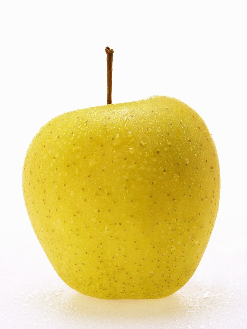 Golden Delicious apple with drops of water