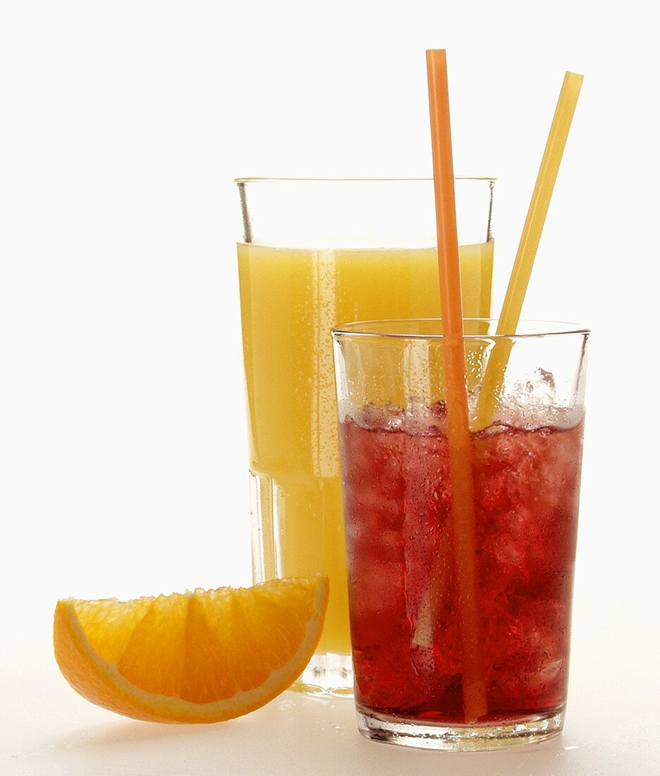 Orange juice; red grape juice with ice cubes; orange wedge