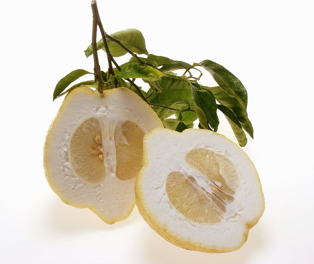 Lemon halves with twig and leaves
