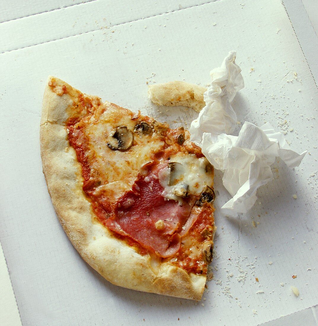 Pizza remains with napkin in cardboard box