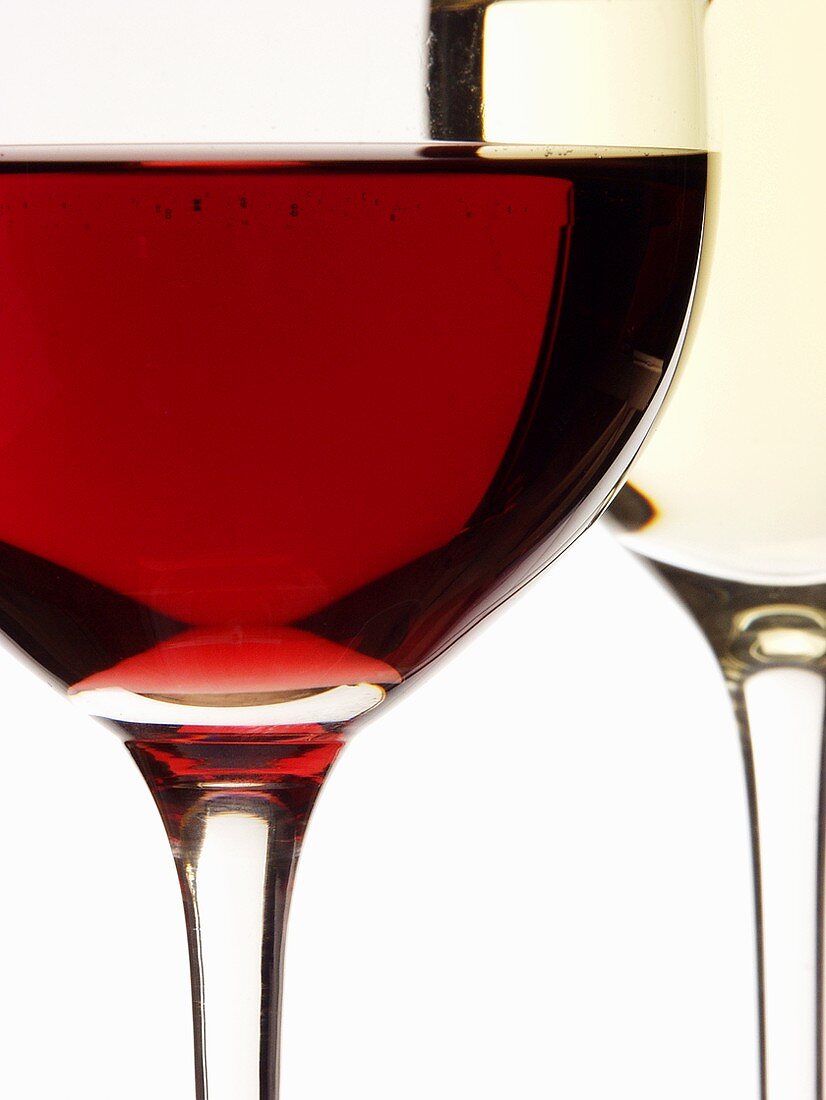 Red wine glass in front of white wine glass (close-up)