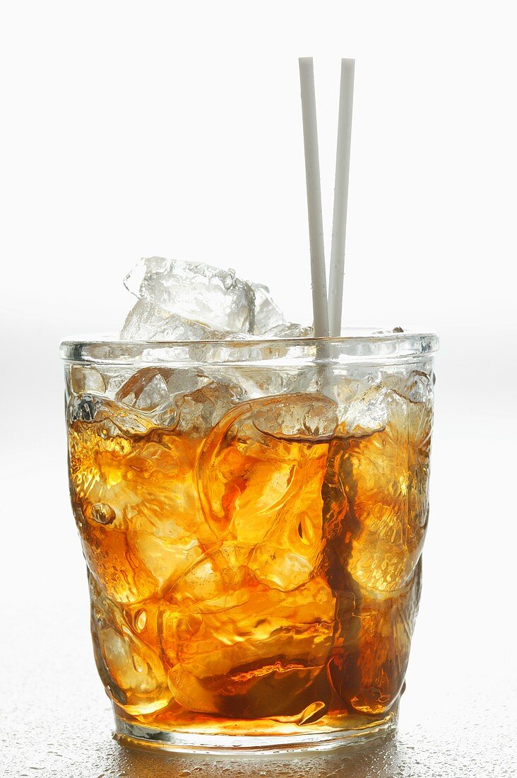 Iced tea in glass with straws