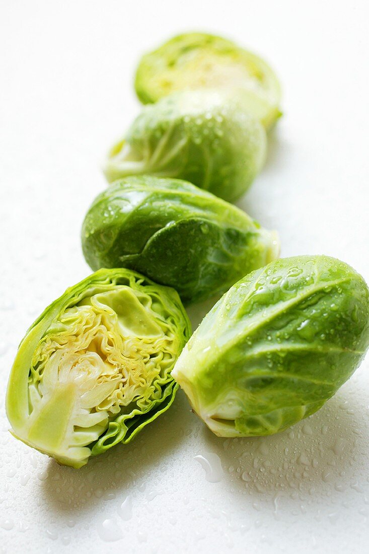Brussels sprouts with drops of water, one halved