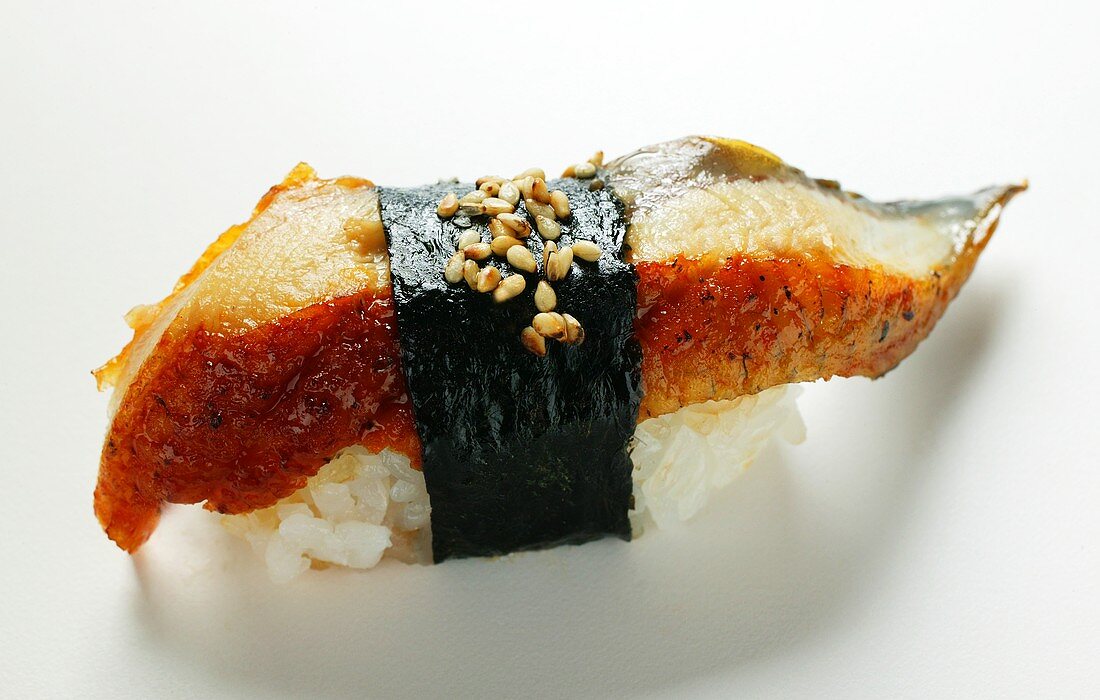 Nigiri sushi with fried mackerel, nori and sesame