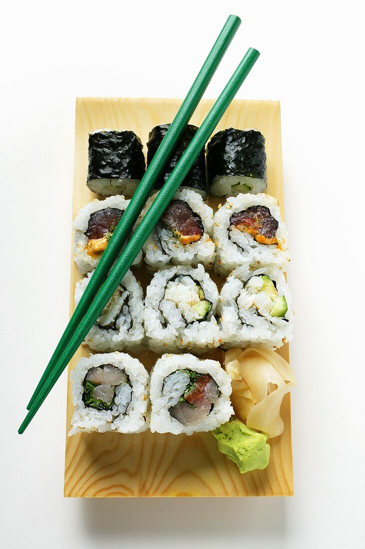 Mixed maki platter with green chopsticks
