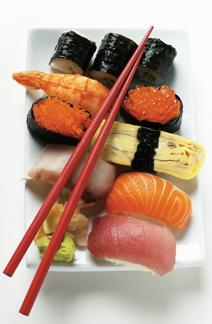 Mixed sushi platter with red chopsticks
