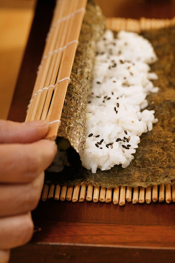 Preparing rolled sushi