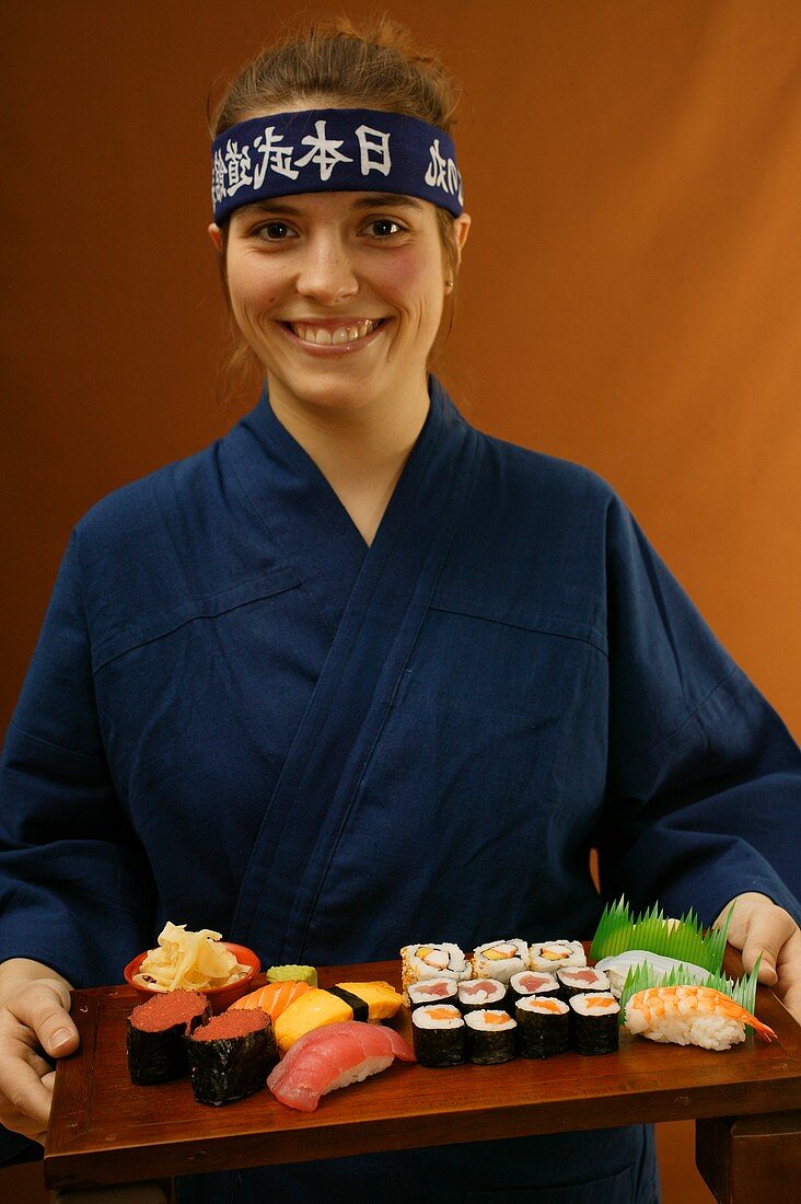 Woman serving sushi platter