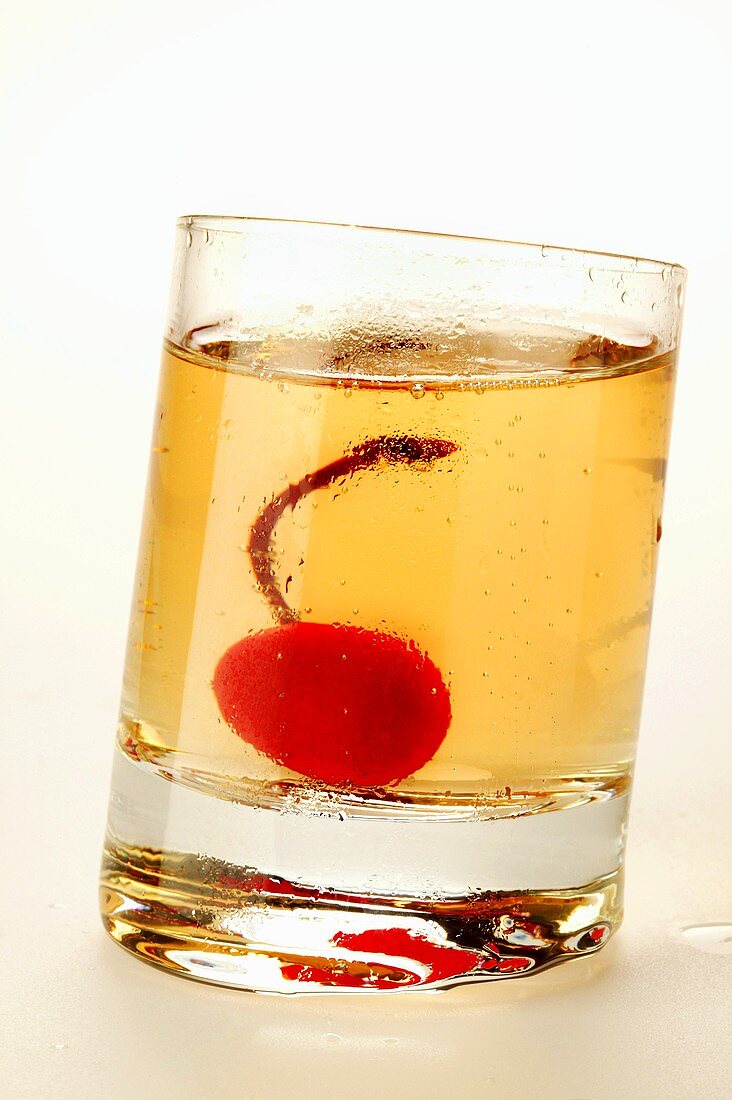 Ginger Ale with cocktail cherry in glass