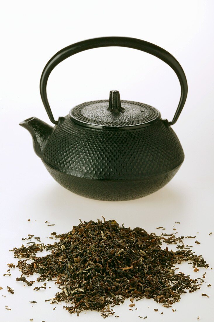 Dry tea in front of Asian teapot