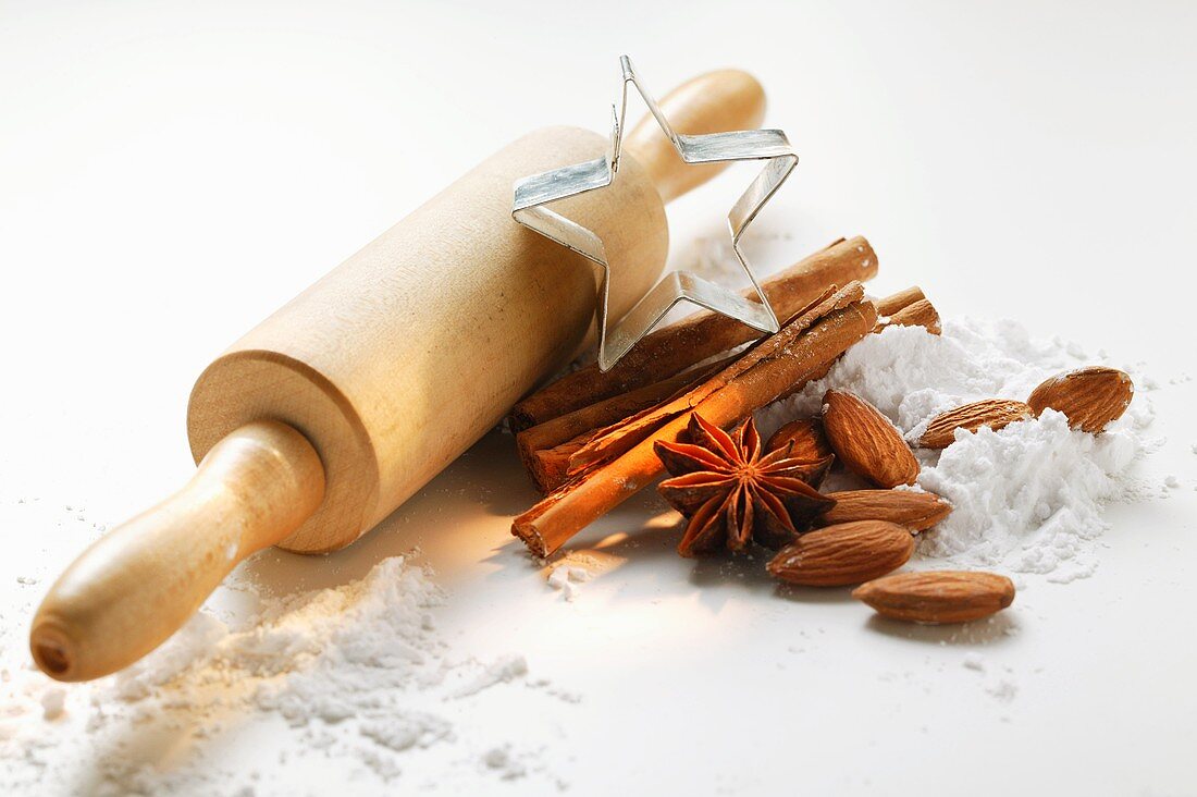 Spices, almonds, icing sugar, rolling pin and cutter