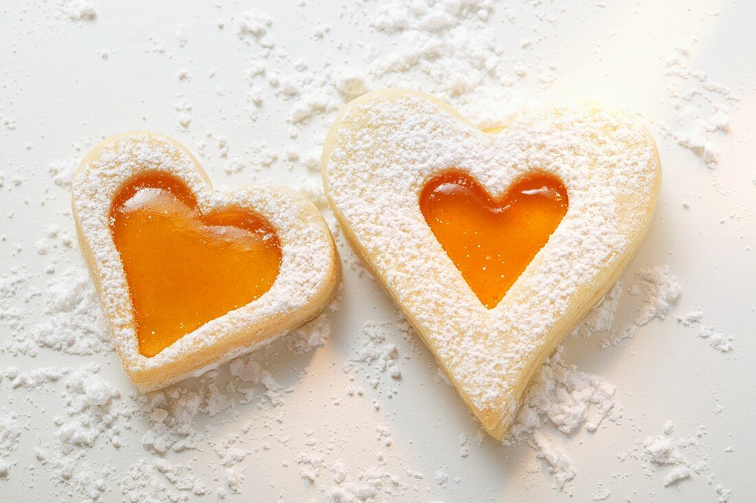 Sweet pastry hearts with apricot jam and icing sugar