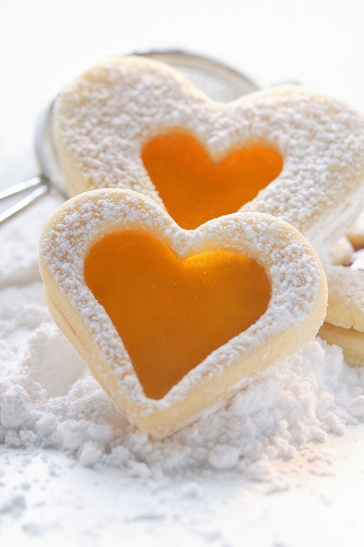 Sweet pastry hearts with apricot jam and icing sugar