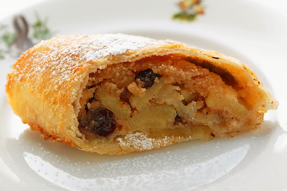 A piece of apple strudel with icing sugar