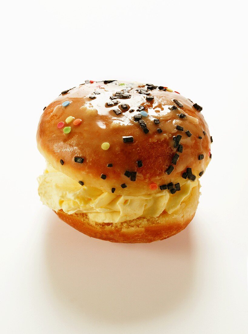 A doughnut with vanilla cream filling and glacé icing